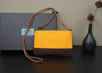 Two-tone shoulder bag with mustard top, brown bottom panel, and braided strap handles