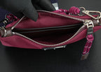 Prada handbag interior view with open zipper, silver zipper teeth, and magenta lining