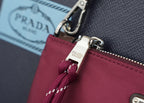 Prada handbag zipper pull and metal hardware on magenta fabric with braided cord