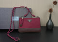 Prada handbag with magenta top handle, braided strap, and silver hardware
