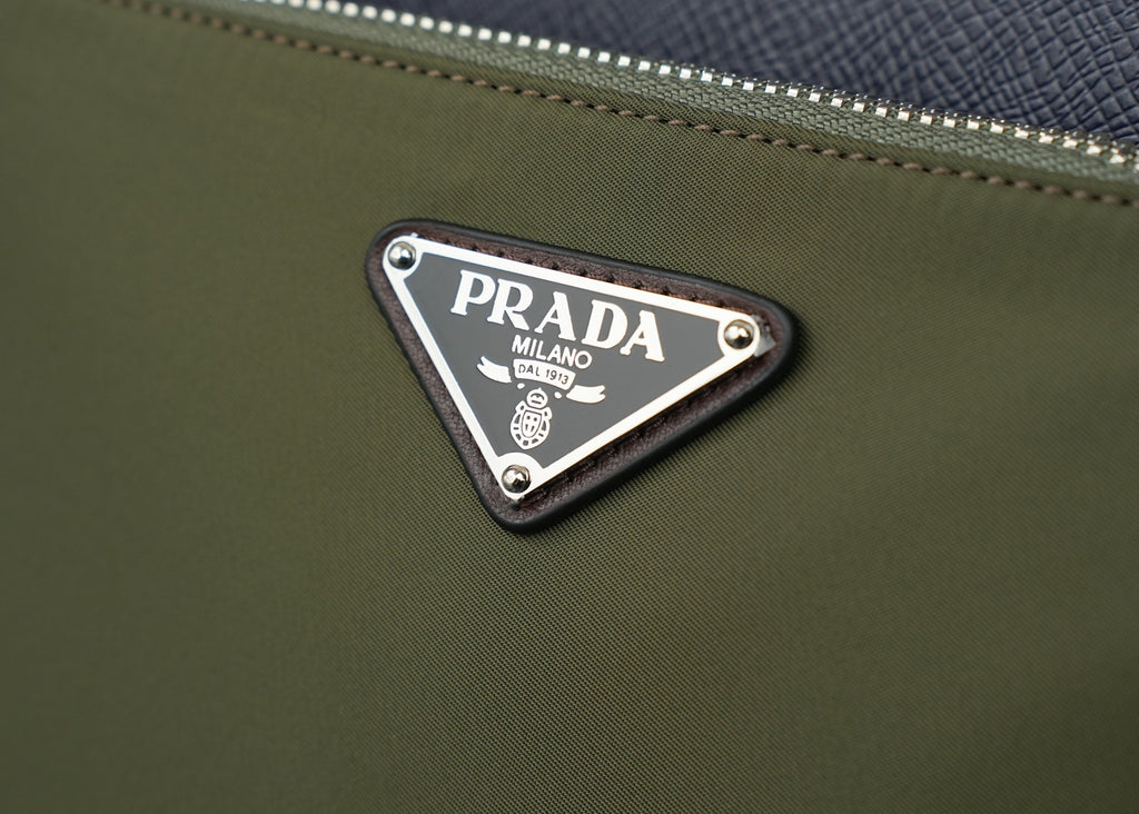 Prada logo plaque on olive fabric bag with silver studs and trim