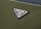 Prada logo plaque on olive fabric bag with silver studs and trim