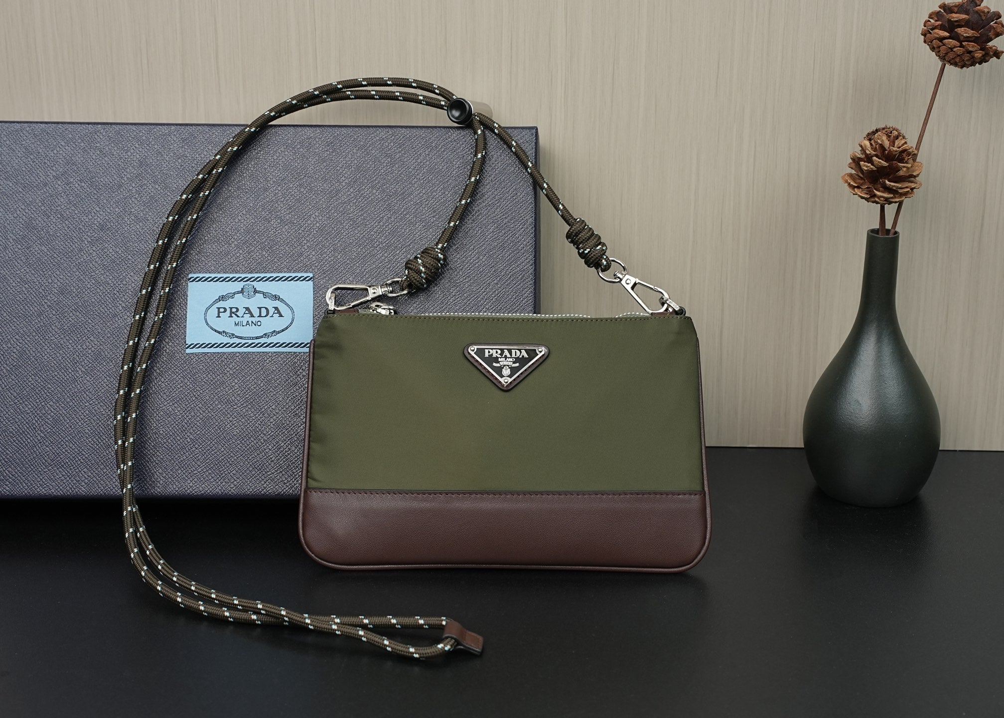 Prada bag with olive body, brown bottom, and chain shoulder strap