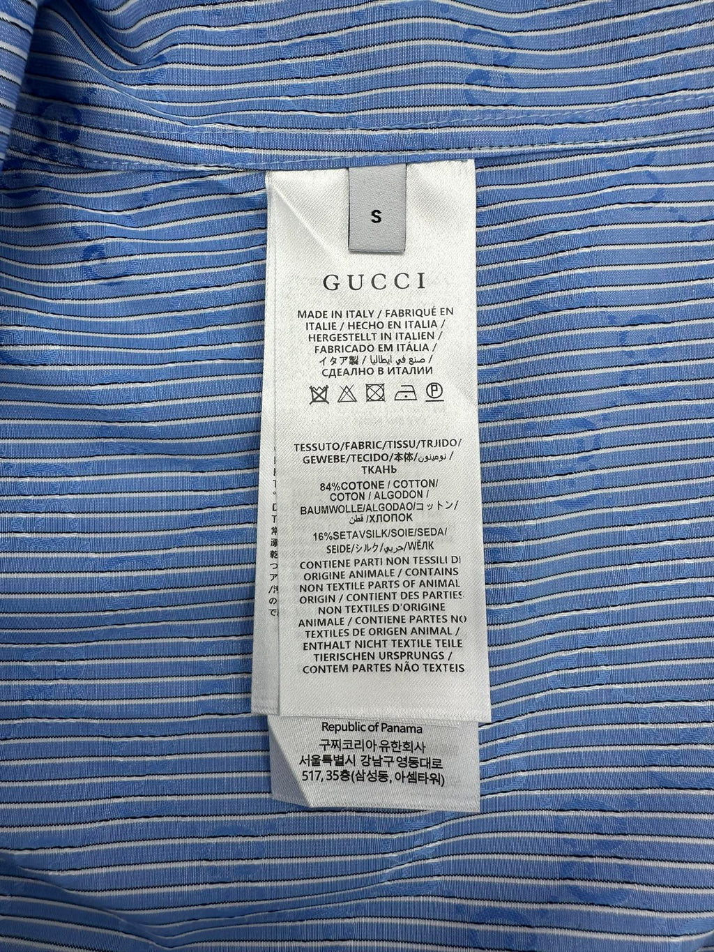 Gucci size and fabric label on blue vertically striped shirt with GG pattern
