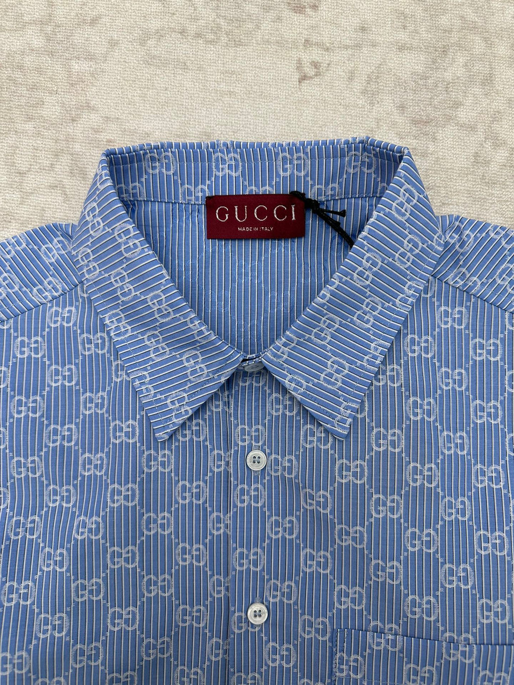 Blue Gucci shirt collar and front placket with GG monogram pattern and buttons