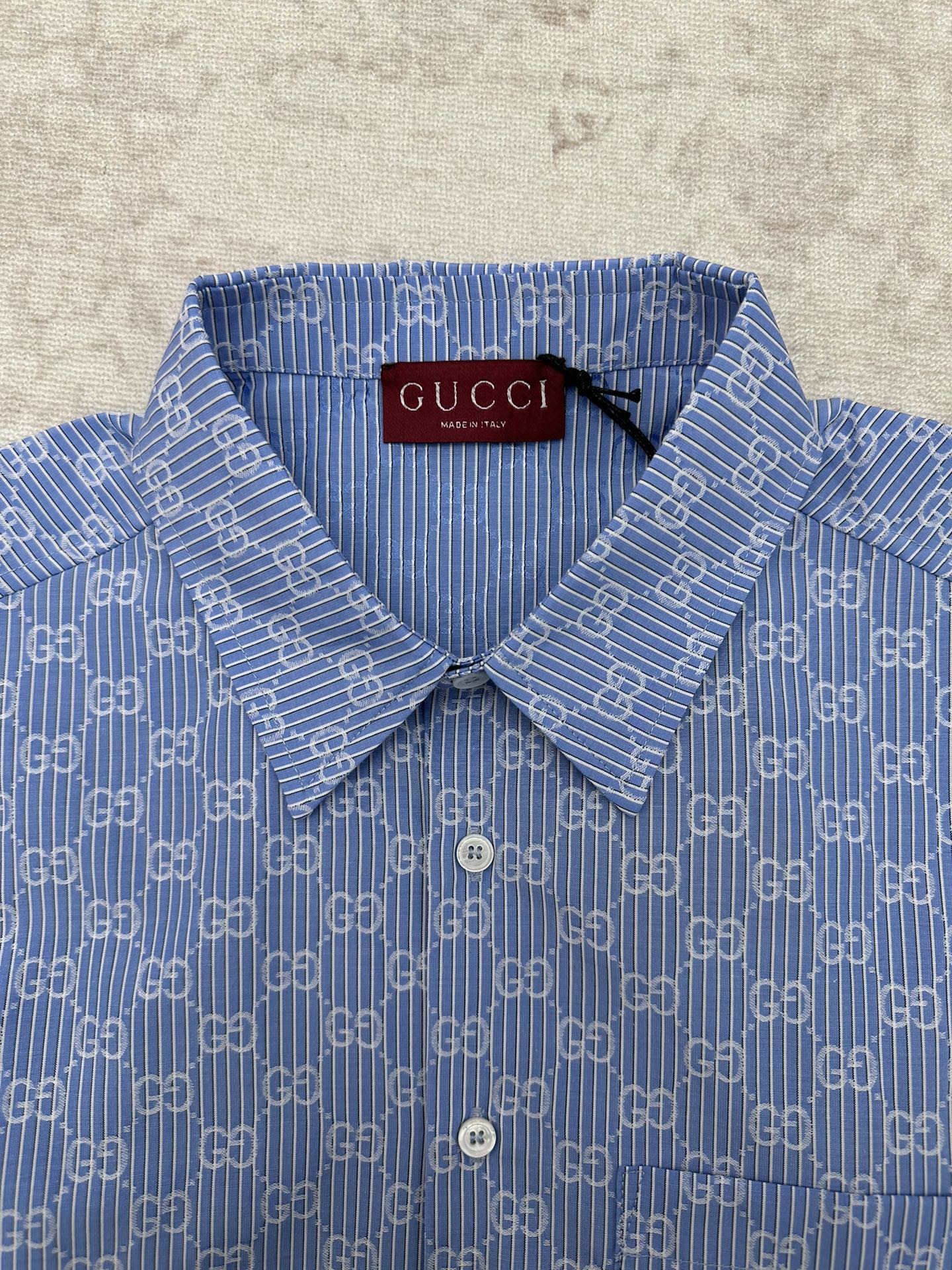 Blue Gucci shirt collar and front placket with GG monogram pattern and buttons
