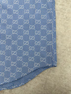 Blue Gucci shirt hem and side seam with vertical stripe and GG monogram pattern
