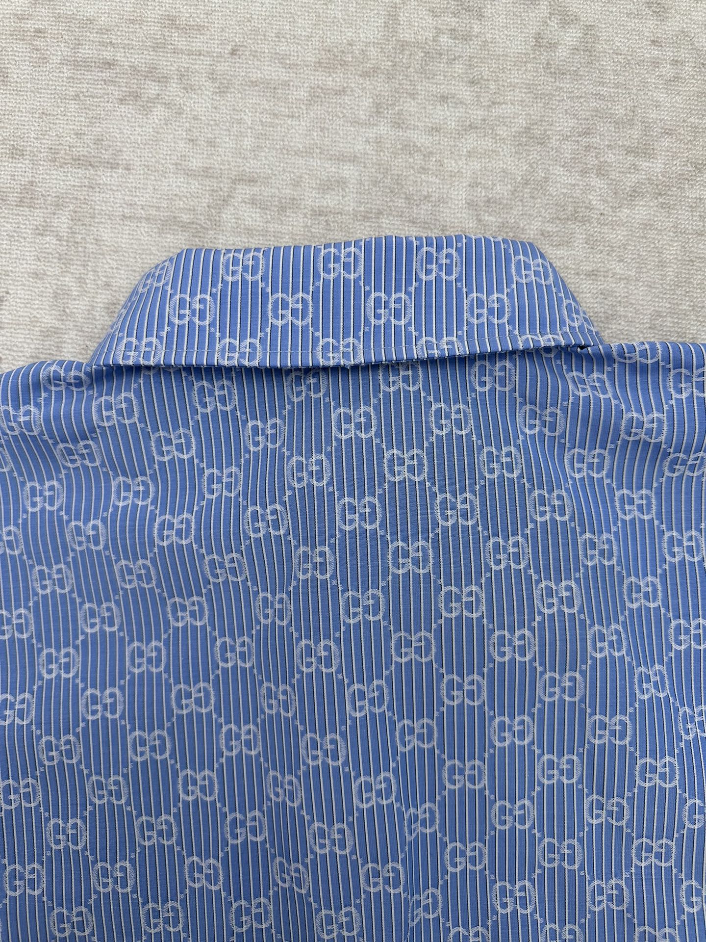 Blue Gucci shirt neckline with GG monogram pattern and button placket