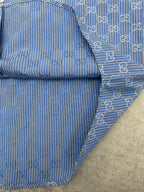 Blue Gucci shirt cuff and sleeve with vertical stripe and GG trim detail