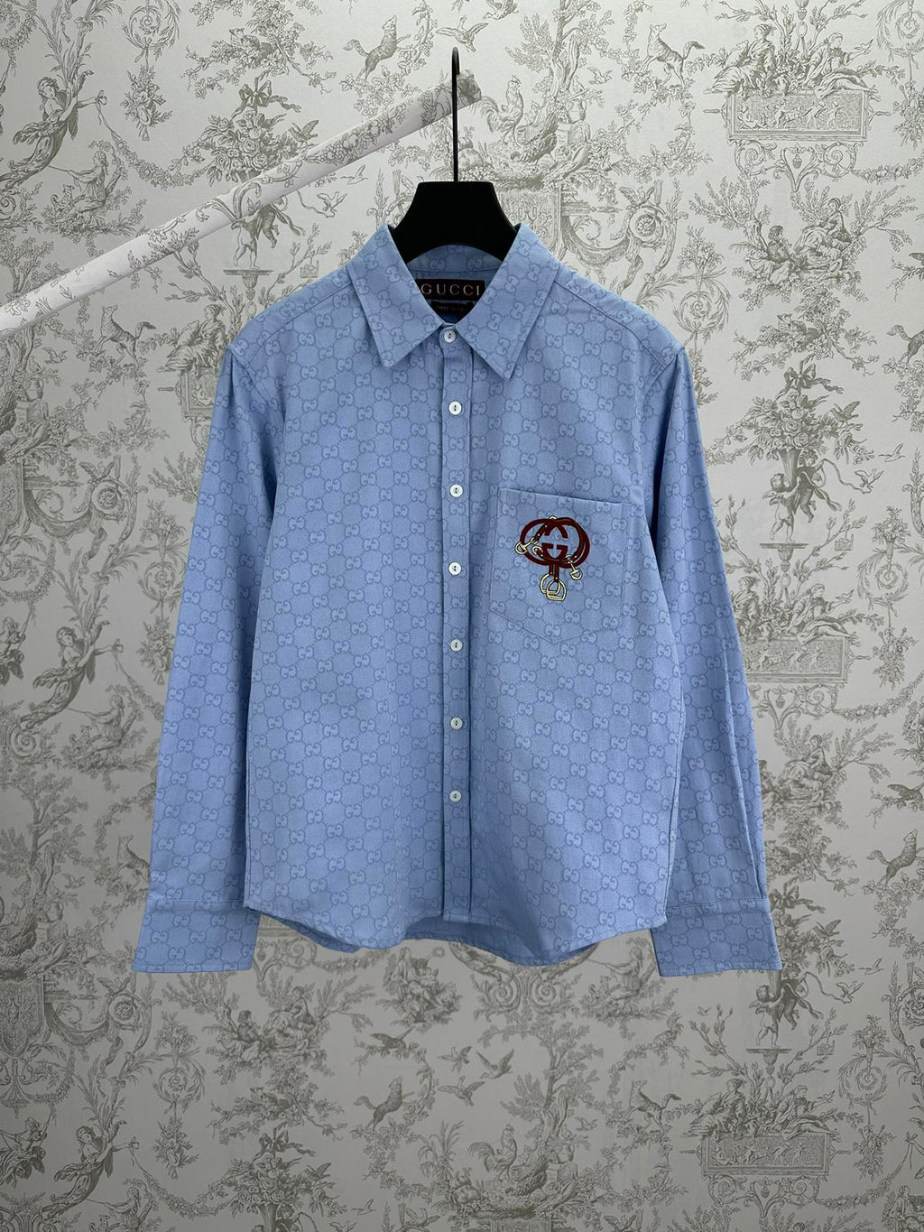 Light blue Gucci button-up shirt with GG monogram and crest emblem on chest