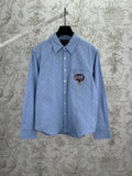 Light blue Gucci button-up shirt with GG monogram and crest emblem on chest