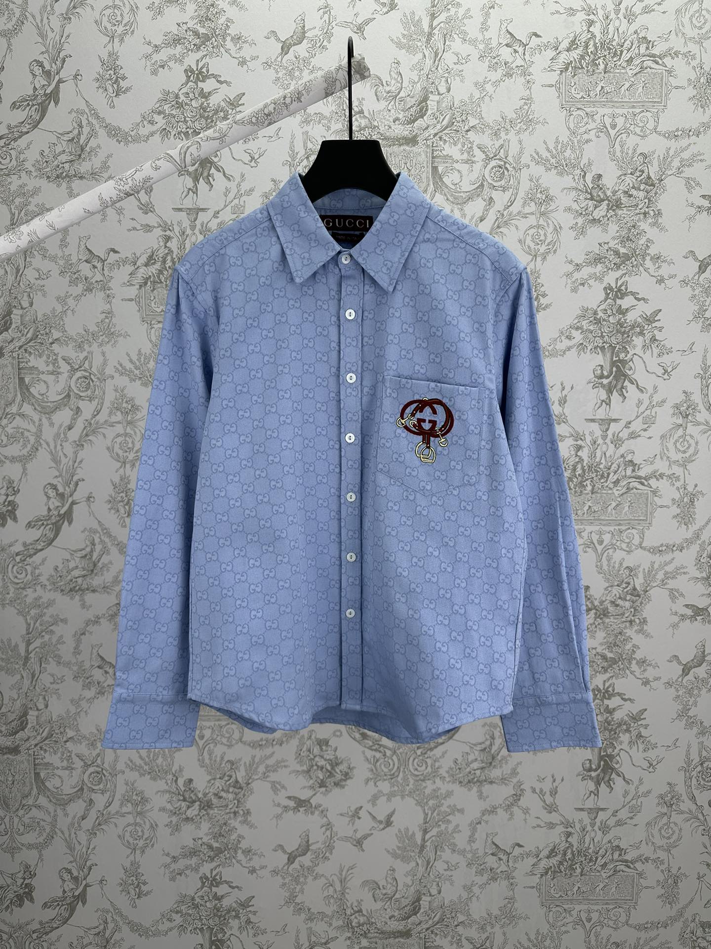 Light blue Gucci button-up shirt with GG monogram and crest emblem on chest