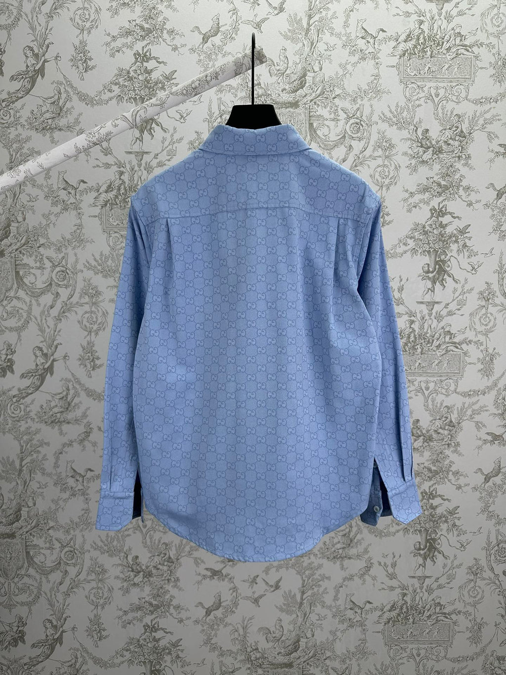Light blue Gucci button-up shirt with GG monogram, back view on hanger
