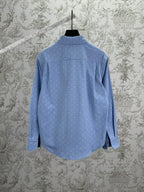 Light blue Gucci button-up shirt with GG monogram, back view on hanger