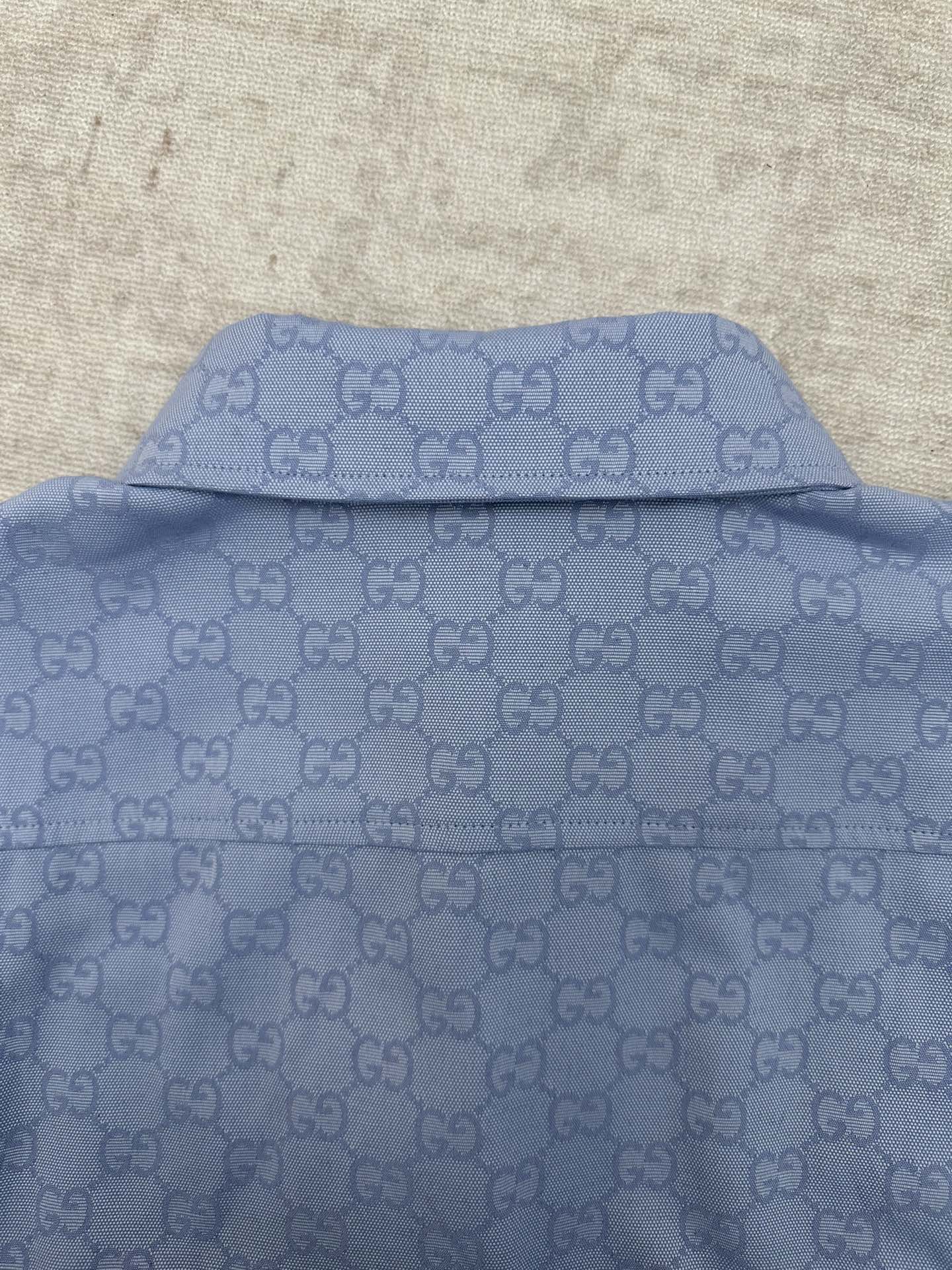 Light blue Gucci button-up shirt back yoke and collar seam with GG monogram
