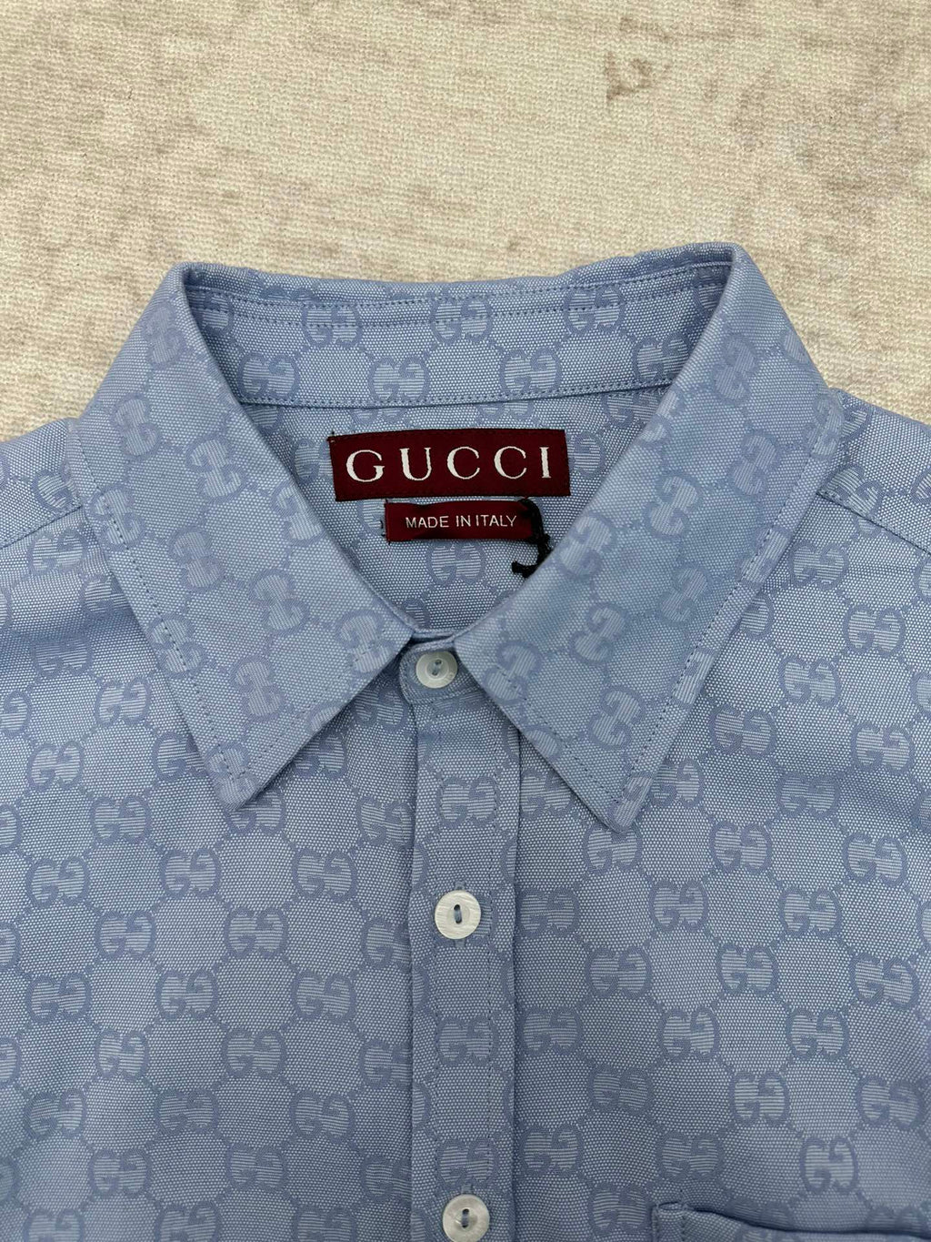 Light blue Gucci button-up shirt with GG monogram, buttoned collar and neckline tag