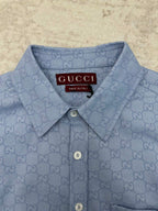 Light blue Gucci button-up shirt with GG monogram, buttoned collar and neckline tag