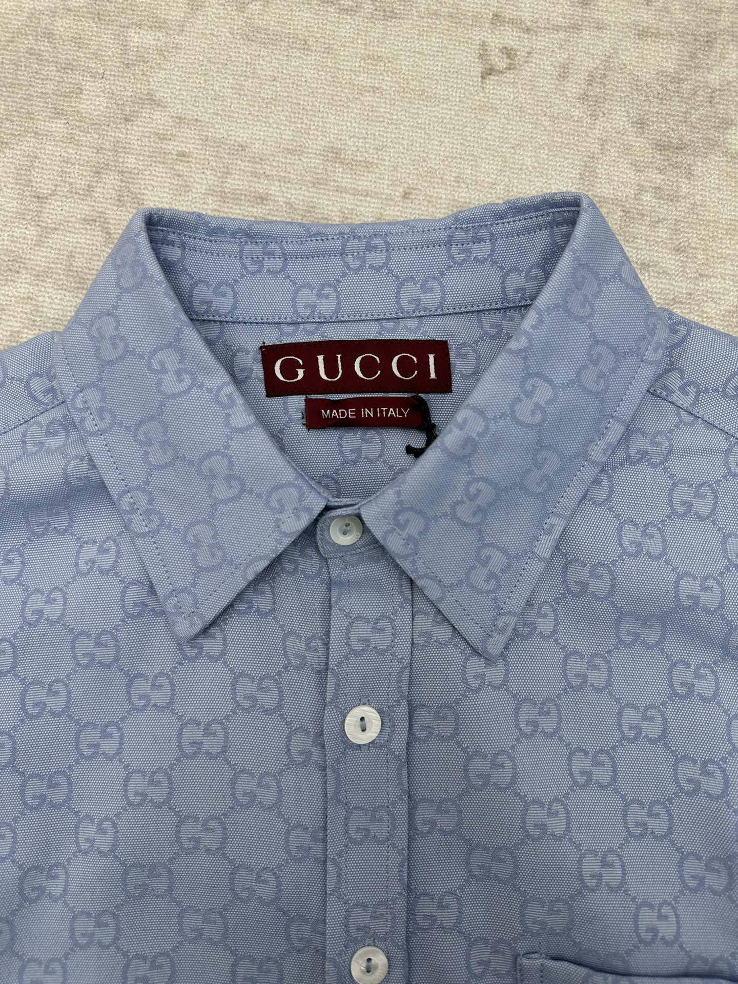 Light blue Gucci button-up shirt with GG monogram, buttoned collar and neckline tag