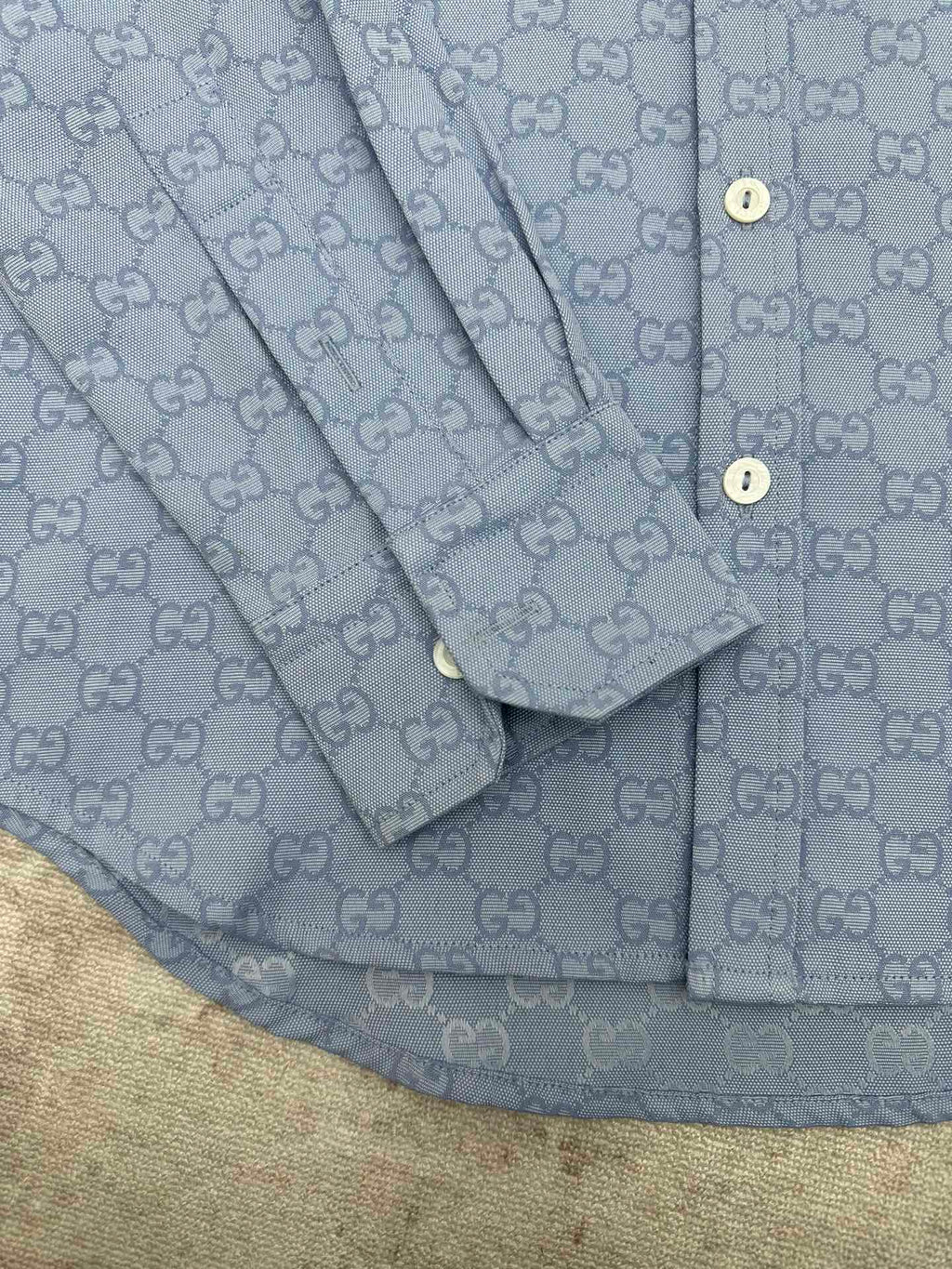 Light blue Gucci button-up shirt sleeve and placket detail with GG monogram