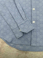 Light blue Gucci button-up shirt sleeve and placket detail with GG monogram