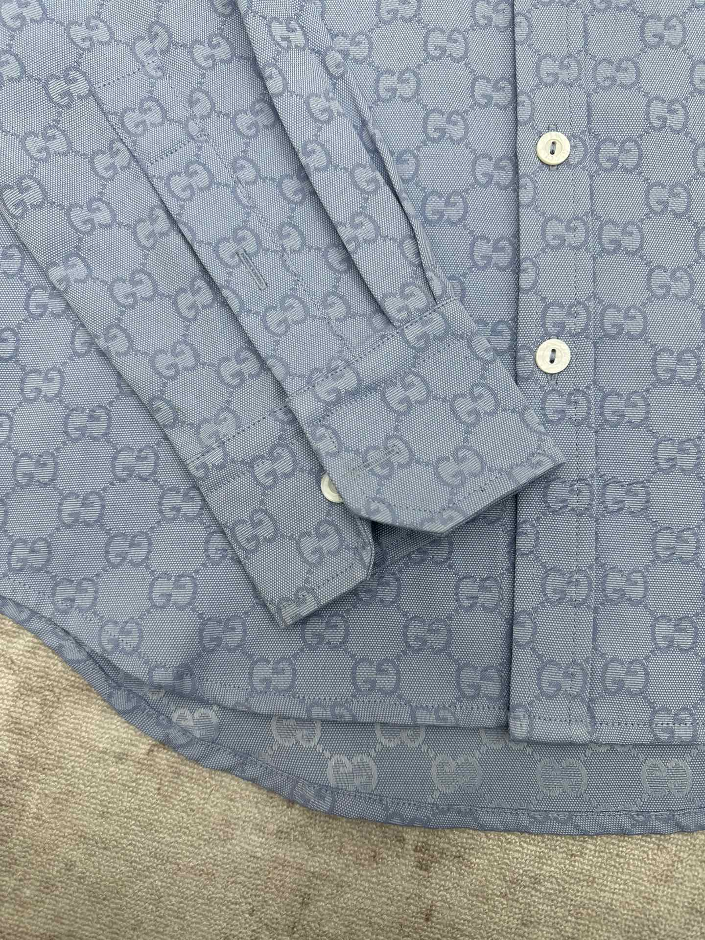 Light blue Gucci button-up shirt sleeve and placket detail with GG monogram