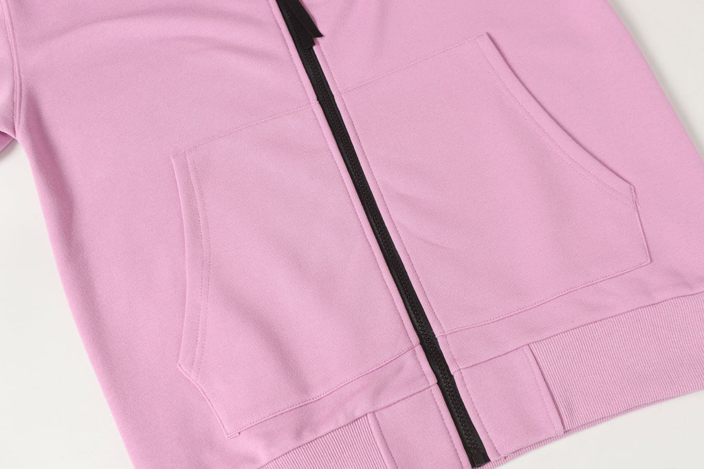 Stone Island hoodie front pockets and black zipper on light pink fabric.