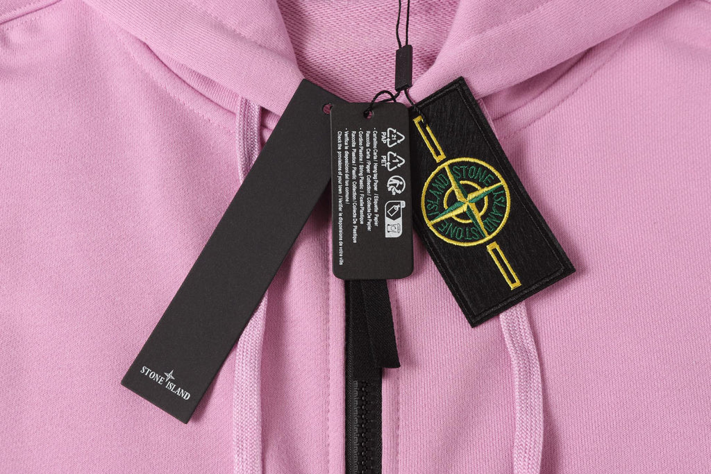 Stone Island hoodie collar with black tags and yellow logo emblem, light pink.
