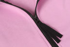 Stone Island hoodie front zipper and black zipper tape on light pink fabric.