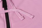 Stone Island hoodie drawstring with black zipper tape on light pink fabric.