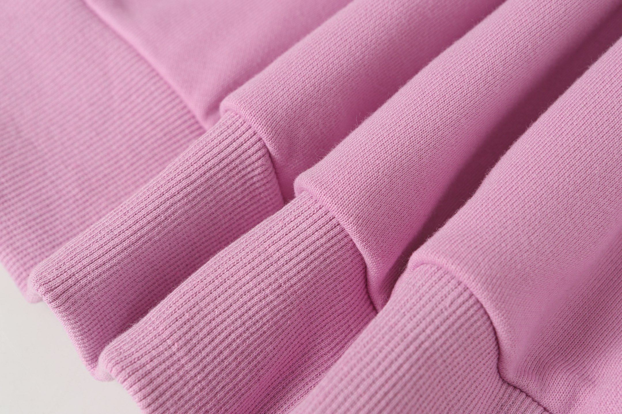 Stone Island hoodie cuffs and hem in light pink rib knit.