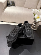 Pair of black lace-up low-top sneakers with Chanel logo, padded collar, rubber sole
