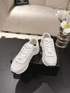 Chanel unisex white lace-up sneakers with cushioned tongue and rounded toe