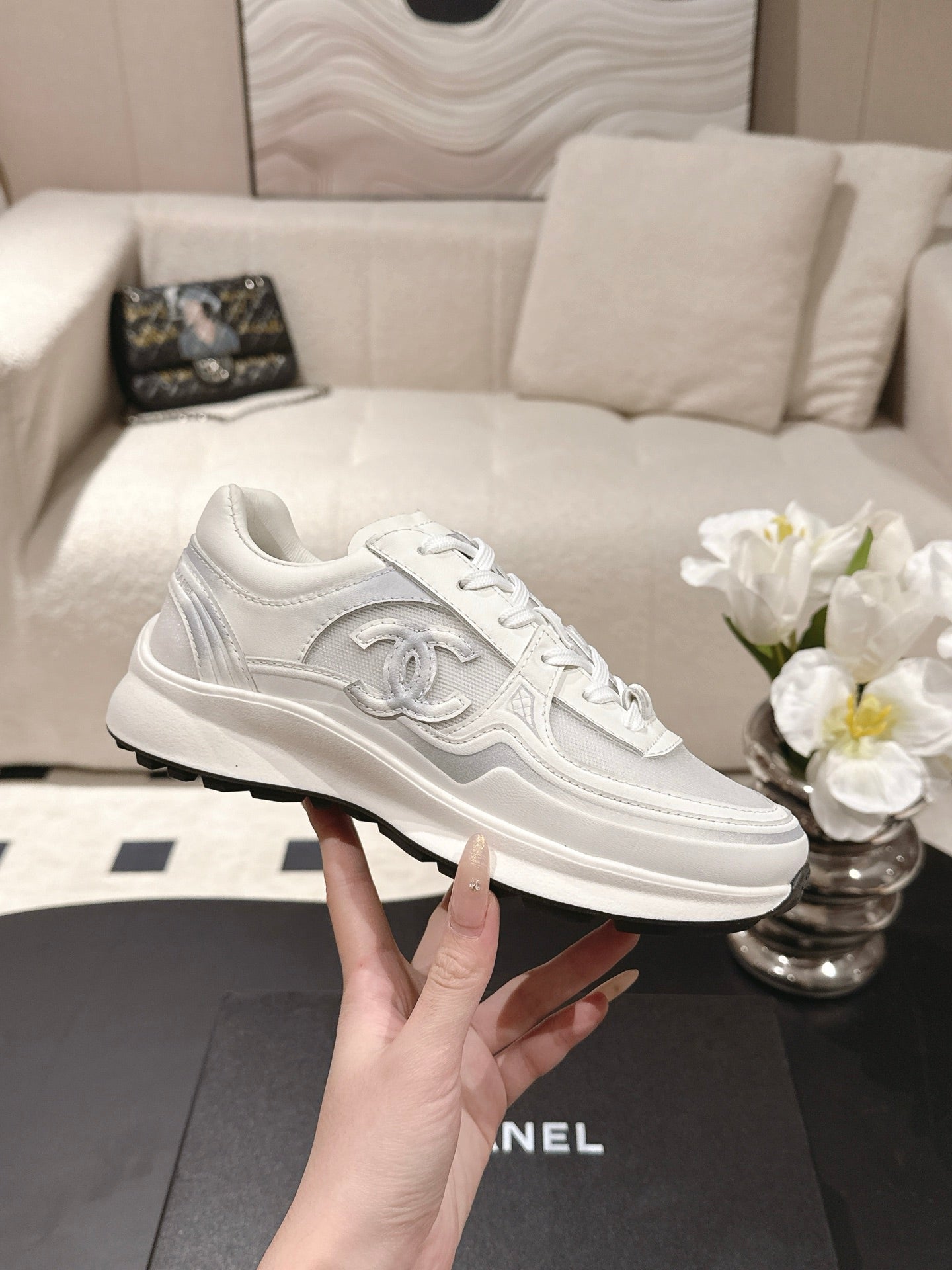 Chanel unisex white sneakers with Chanel-style emblem and textured side panel