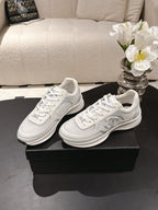 Chanel unisex white leather sneakers with lace-up front and embossed logo