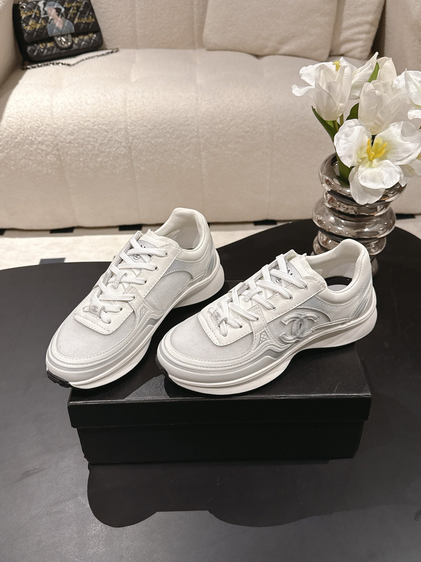 Chanel unisex white leather sneakers with lace-up front and embossed logo