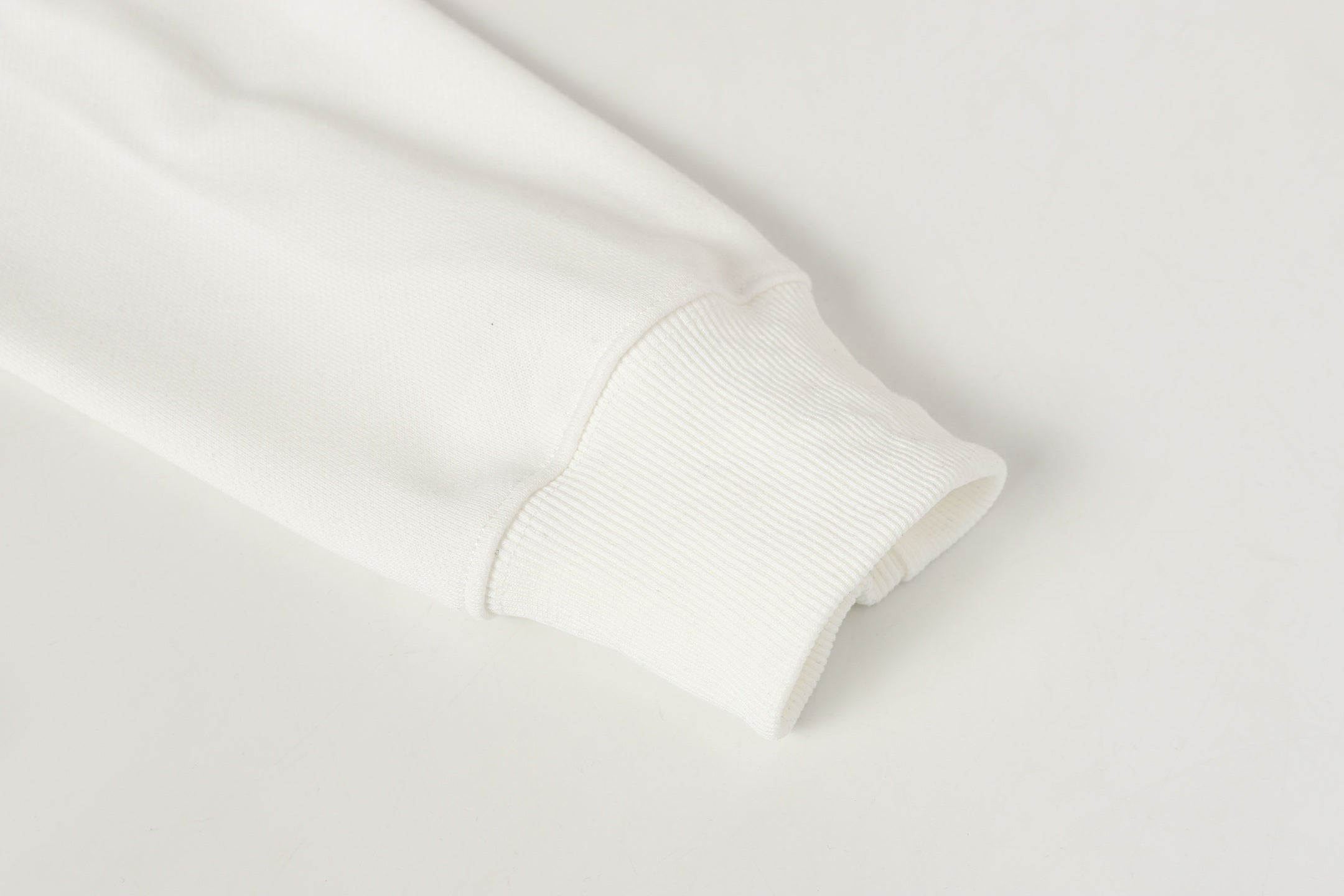 Stone Island white ribbed cuff with soft knit sleeve hem