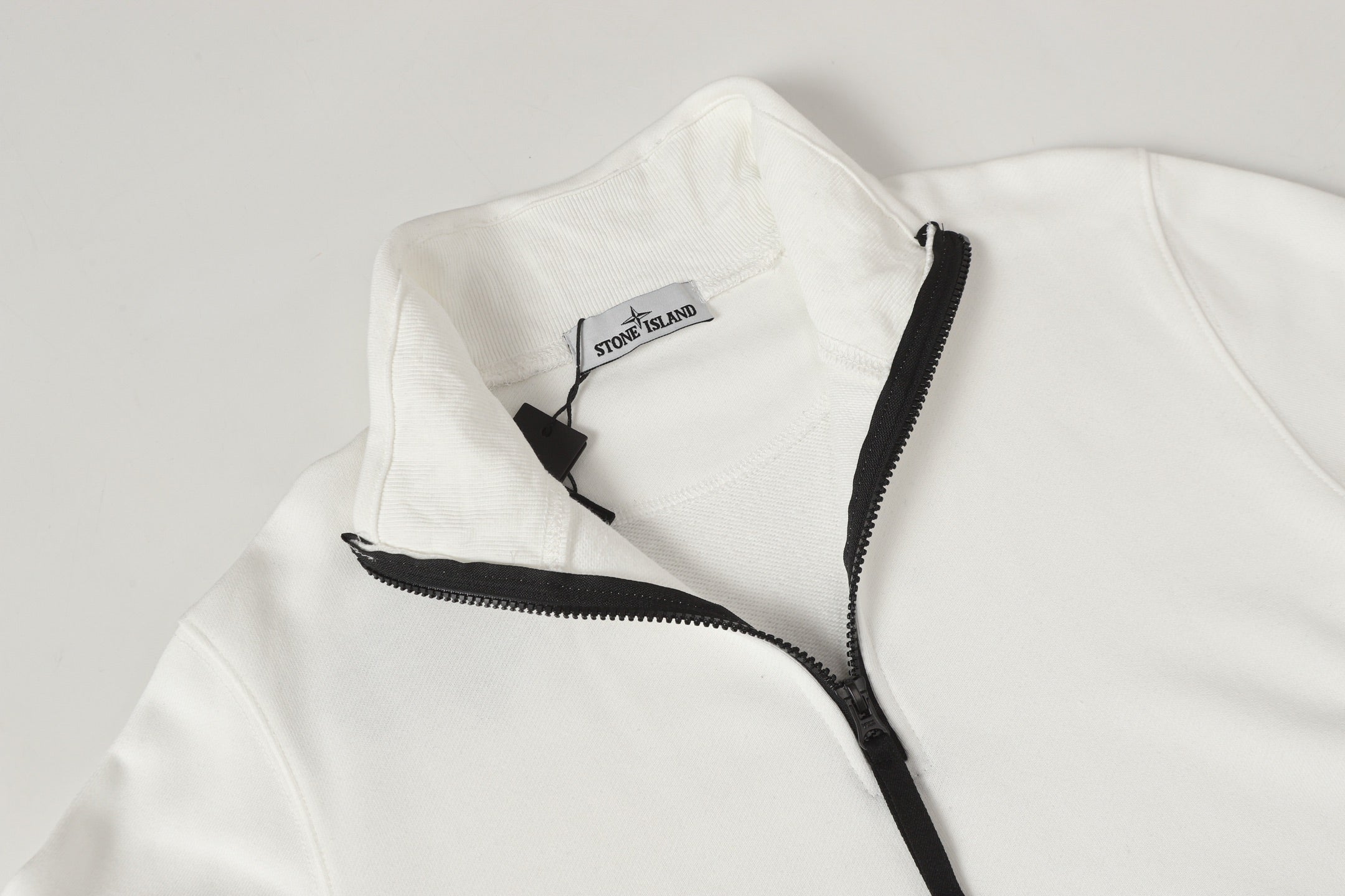 Stone Island white quarter-zip top with black zip and embroidered side logo