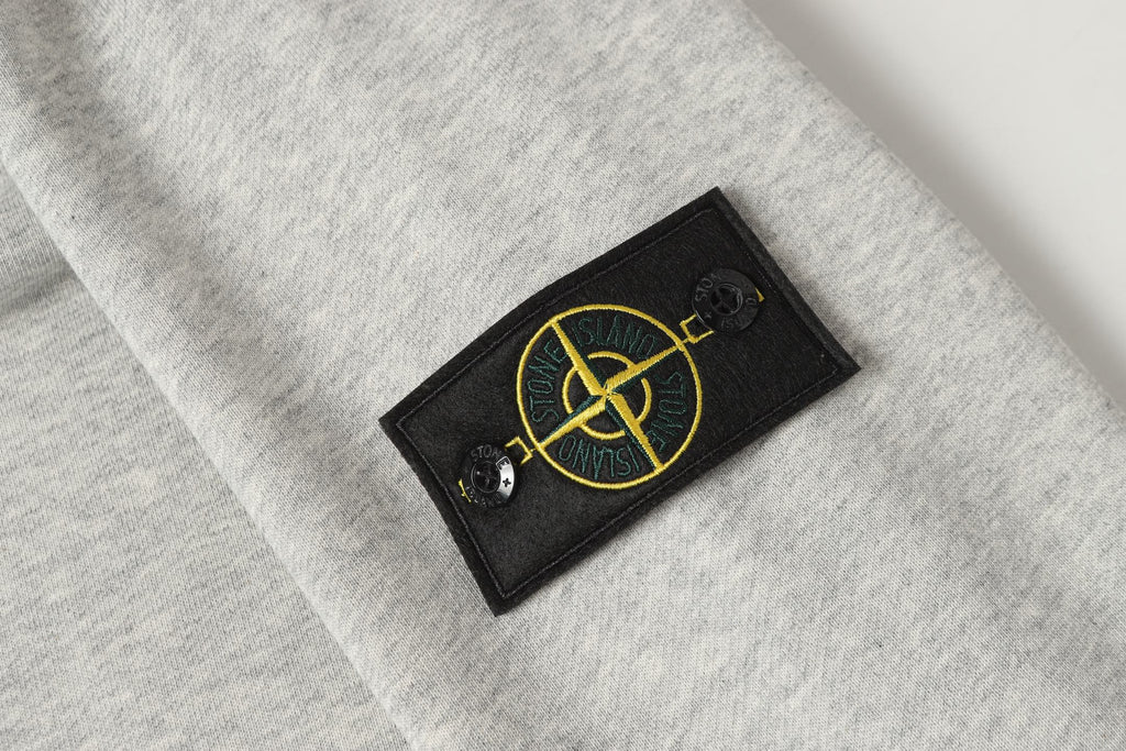 Stone Island logo patch on light gray crewneck sweatshirt chest
