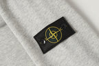 Stone Island logo patch on light gray crewneck sweatshirt chest