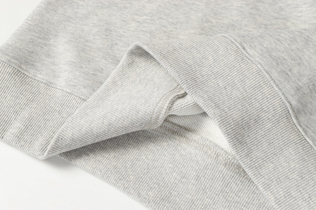 Light gray sweatshirt sleeve cuff with ribbed knit