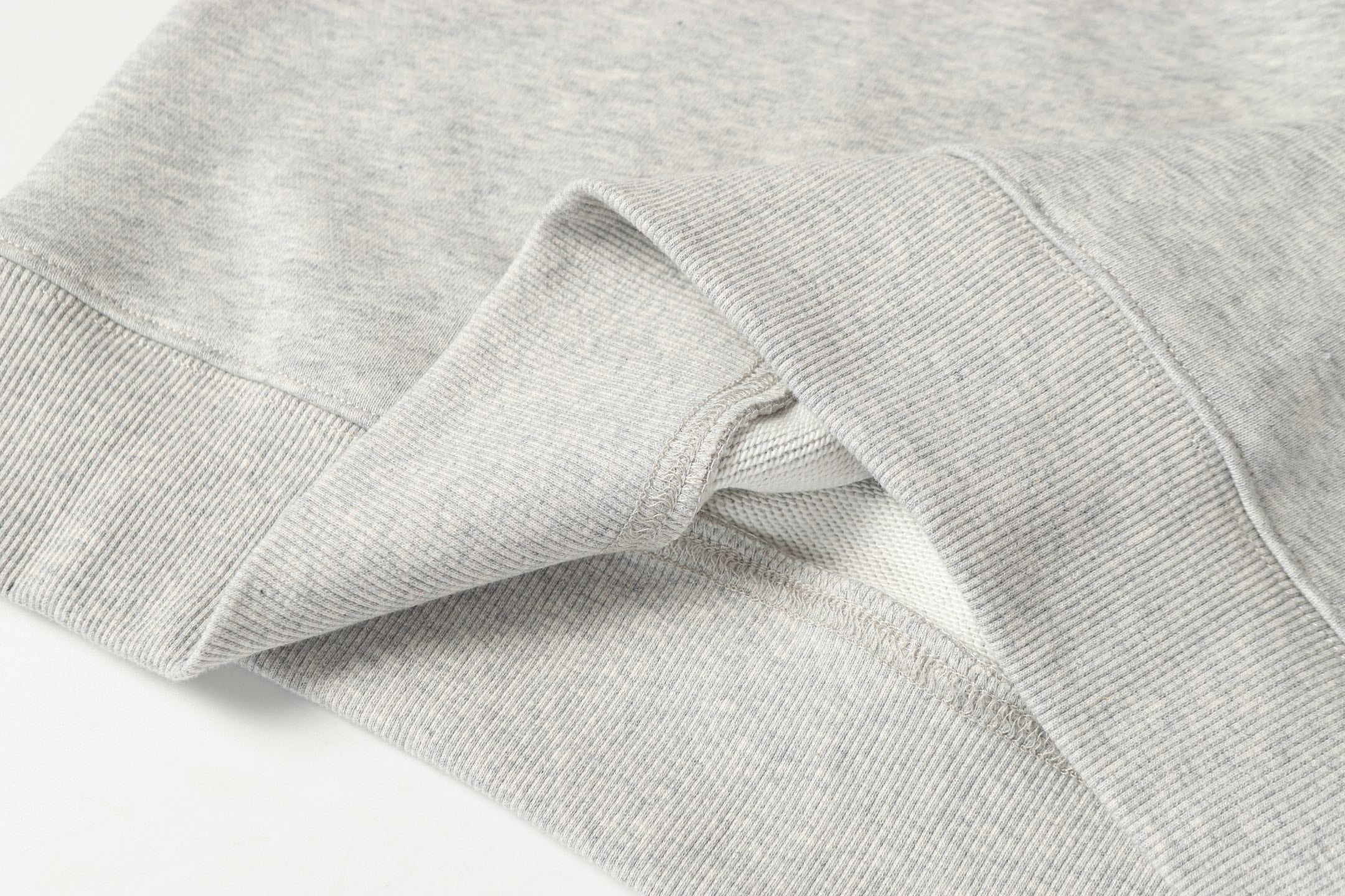 Light gray sweatshirt sleeve cuff with ribbed knit