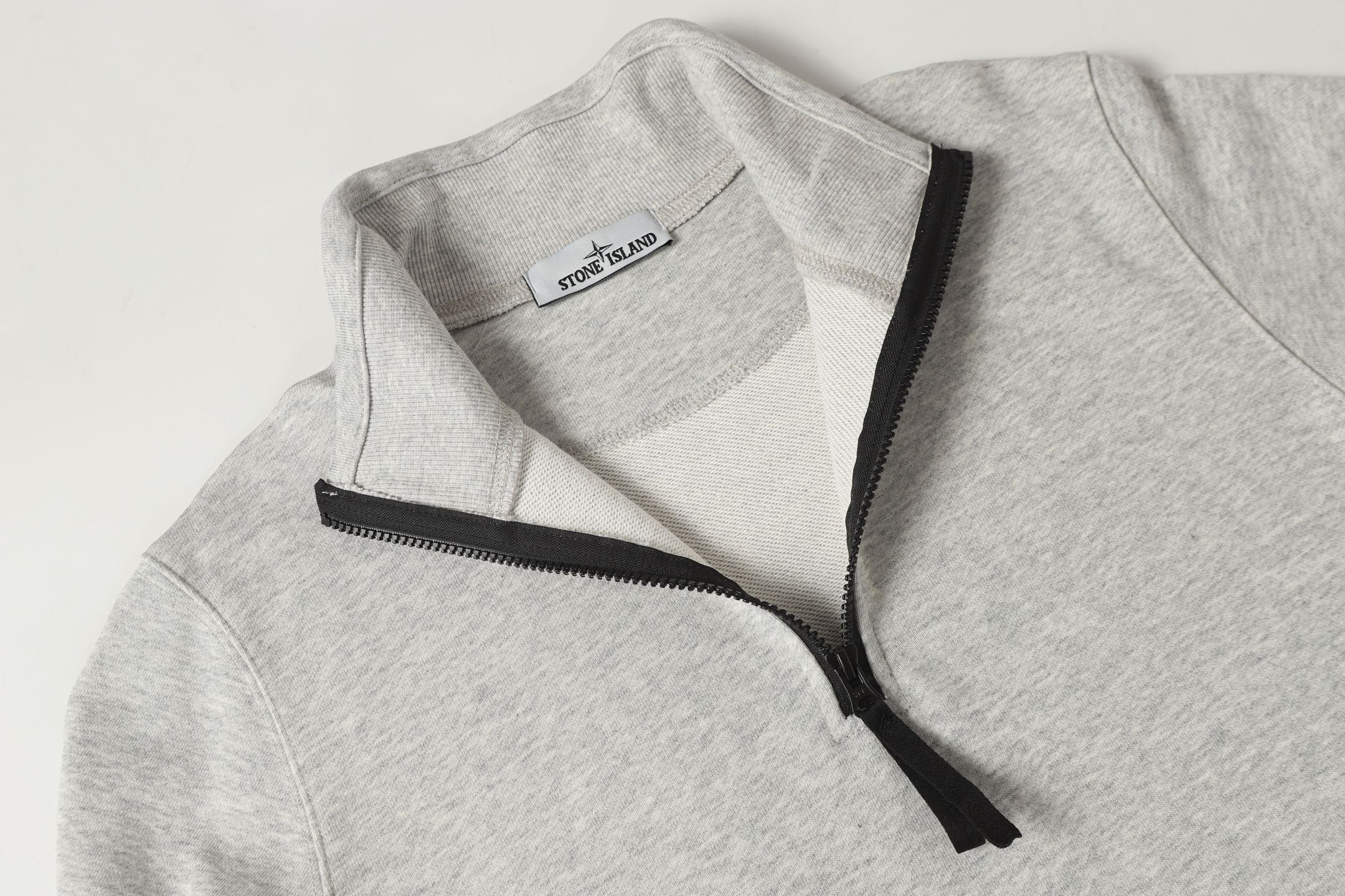 Light gray zip sweatshirt with standing collar and black zipper