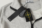 Light gray zip sweatshirt collar with Stone Island label and hanging tags
