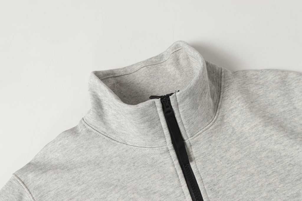 Light gray zip sweatshirt neckline with black zipper track