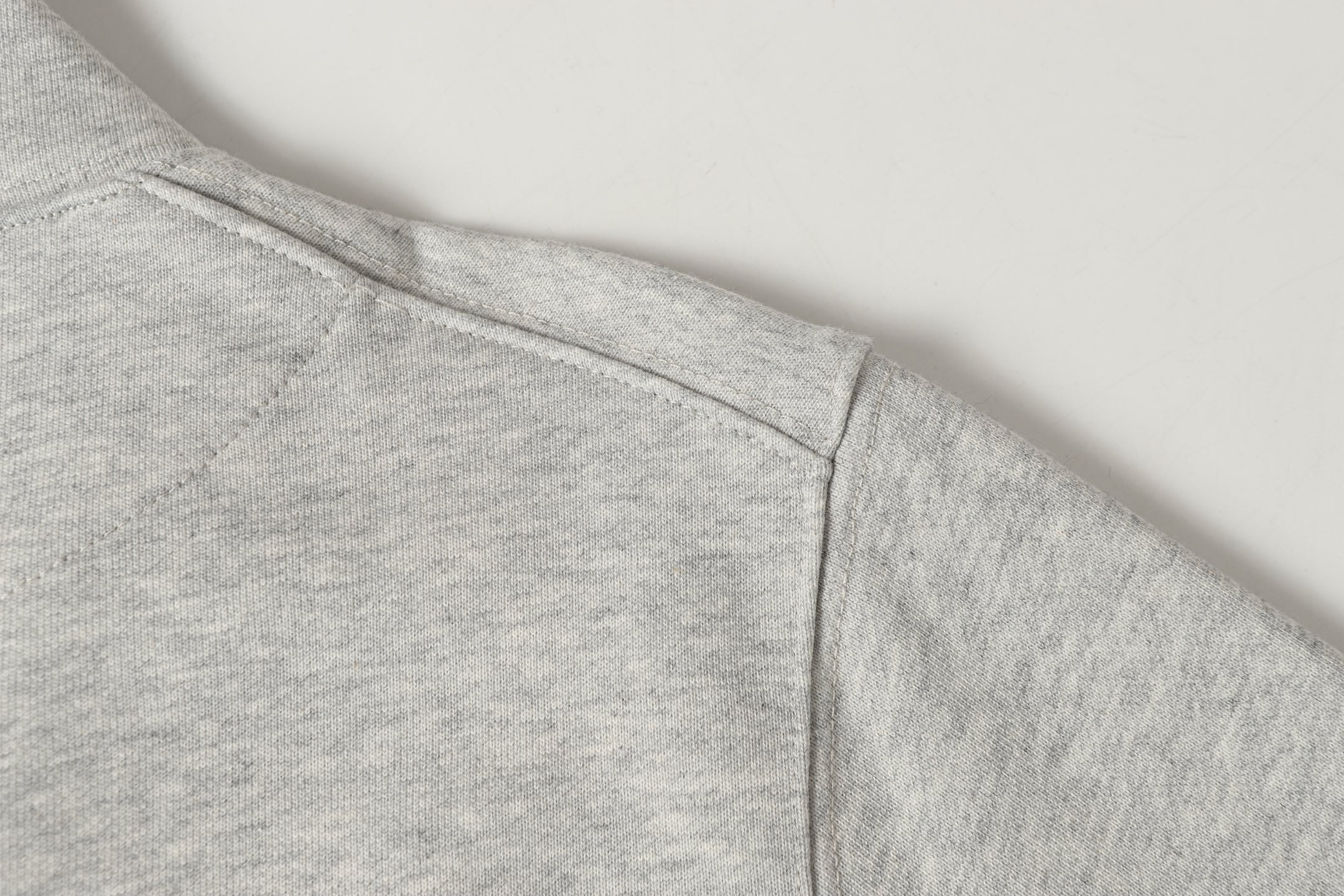 Light gray sweatshirt hem with clean side seam