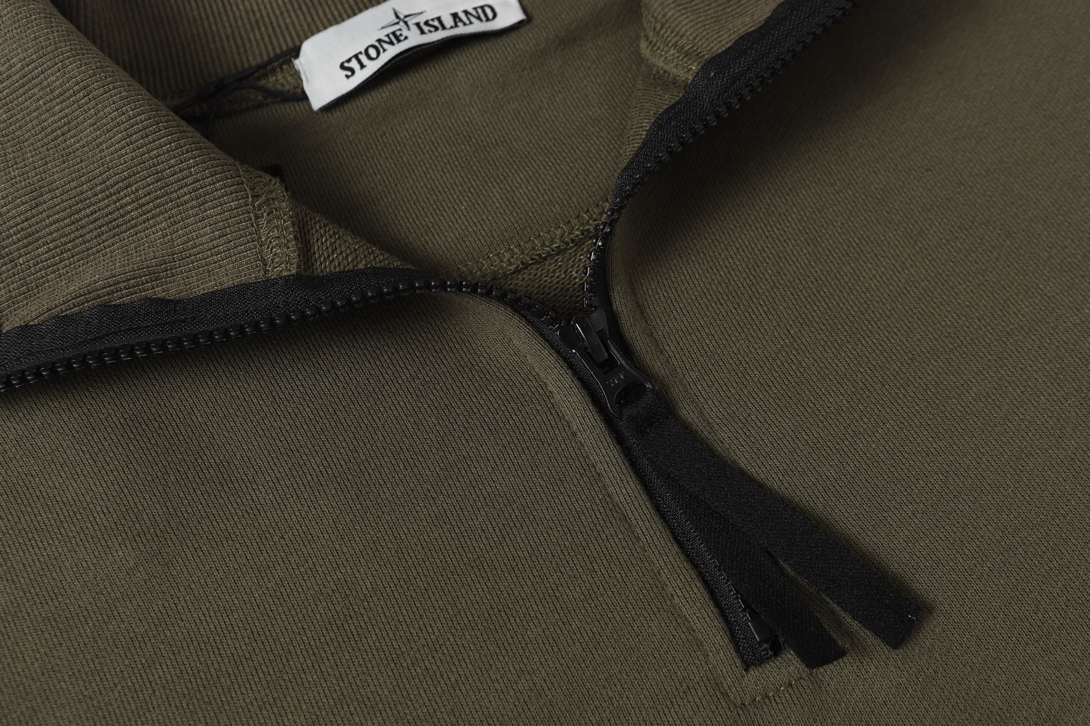 Stone Island quarter-zip sweatshirt chest zipper and dark zipper pull detail