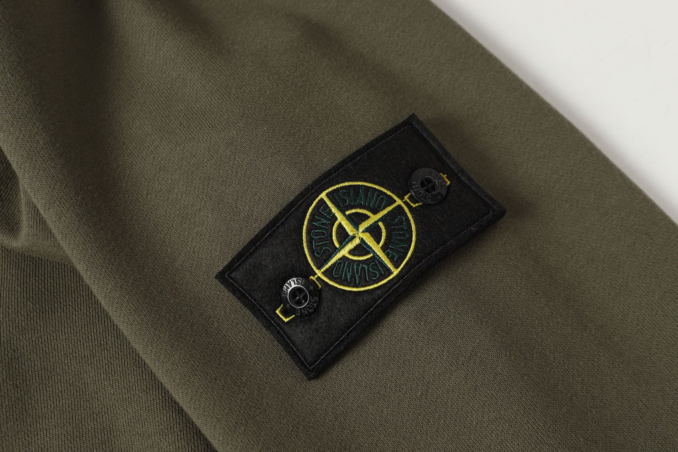 Stone Island quarter-zip sweatshirt with yellow logo patch on sleeve