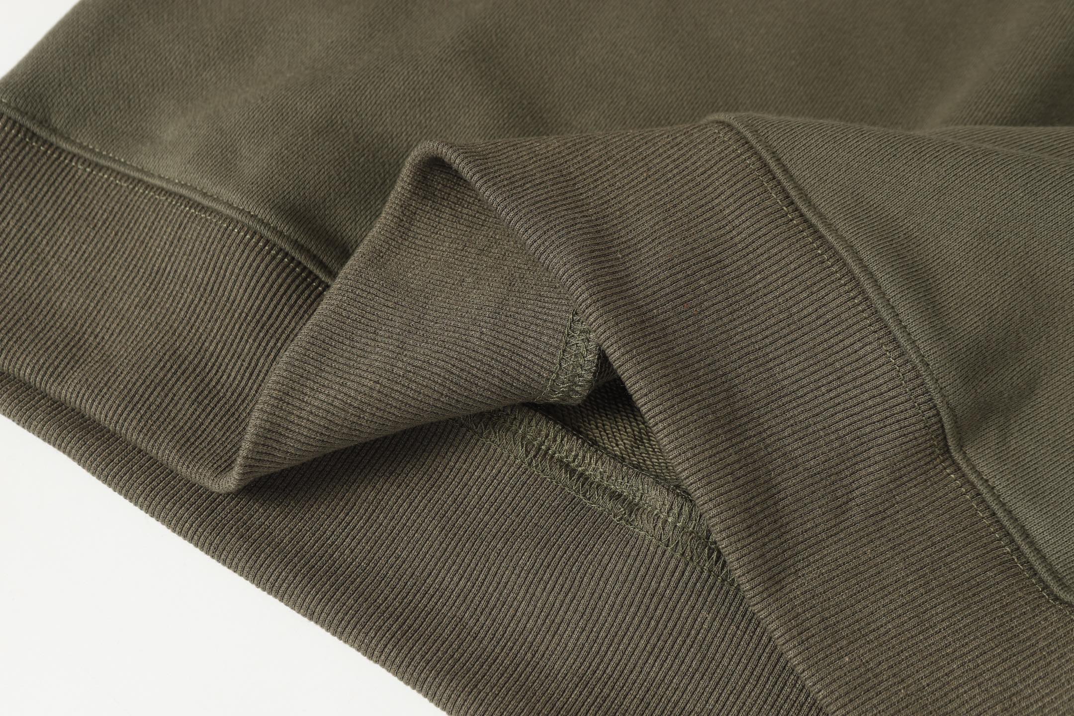 Stone Island quarter-zip sweatshirt seam and side panel detail near hem