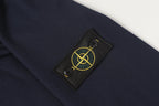 Stone Island logo patch on navy quarter-zip sweatshirt sleeve.
