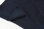 Navy quarter-zip sweatshirt hem with ribbed inner cuff and knit texture.